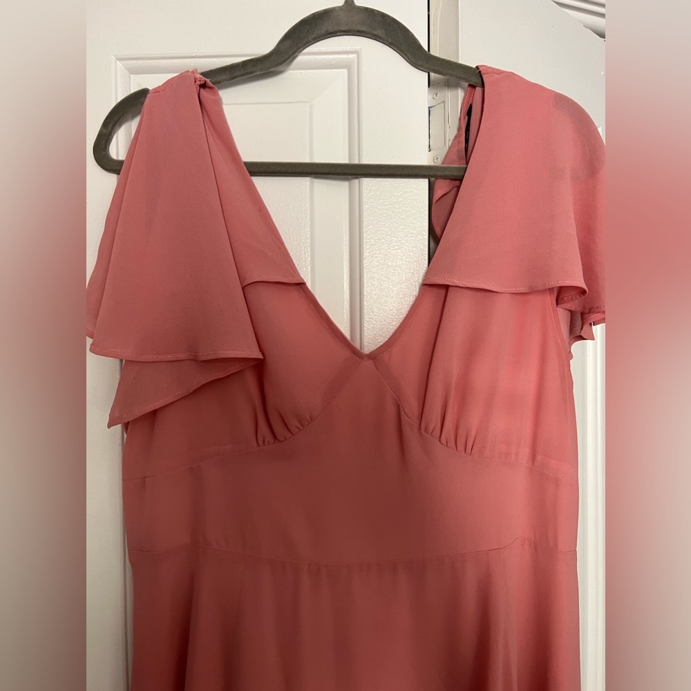Blush pink dress with criss-cross back, has slit on the left side.